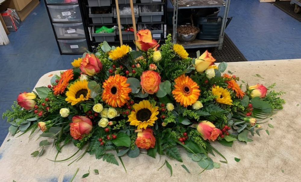 Warm Orange And Yellow Casket Spray